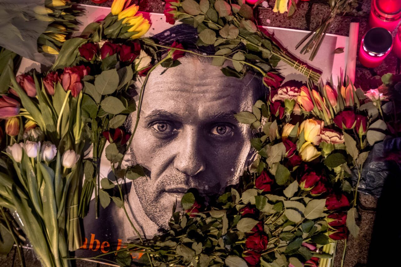 Flowers frame a photo of Russian opposition leader Alexei Navalny, placed near the Russian consulate in Frankfurt, Germany, Feb. 17. Navalny, who crusaded against official corruption and staged massive anti-Kremlin protests as Russian President Vladimir Putin’s fiercest foe, died Friday in the Arctic penal colony where he was serving a 19-year sentence, Russia’s prison agency said. He was 47. (Michael Probst / Associated Press)