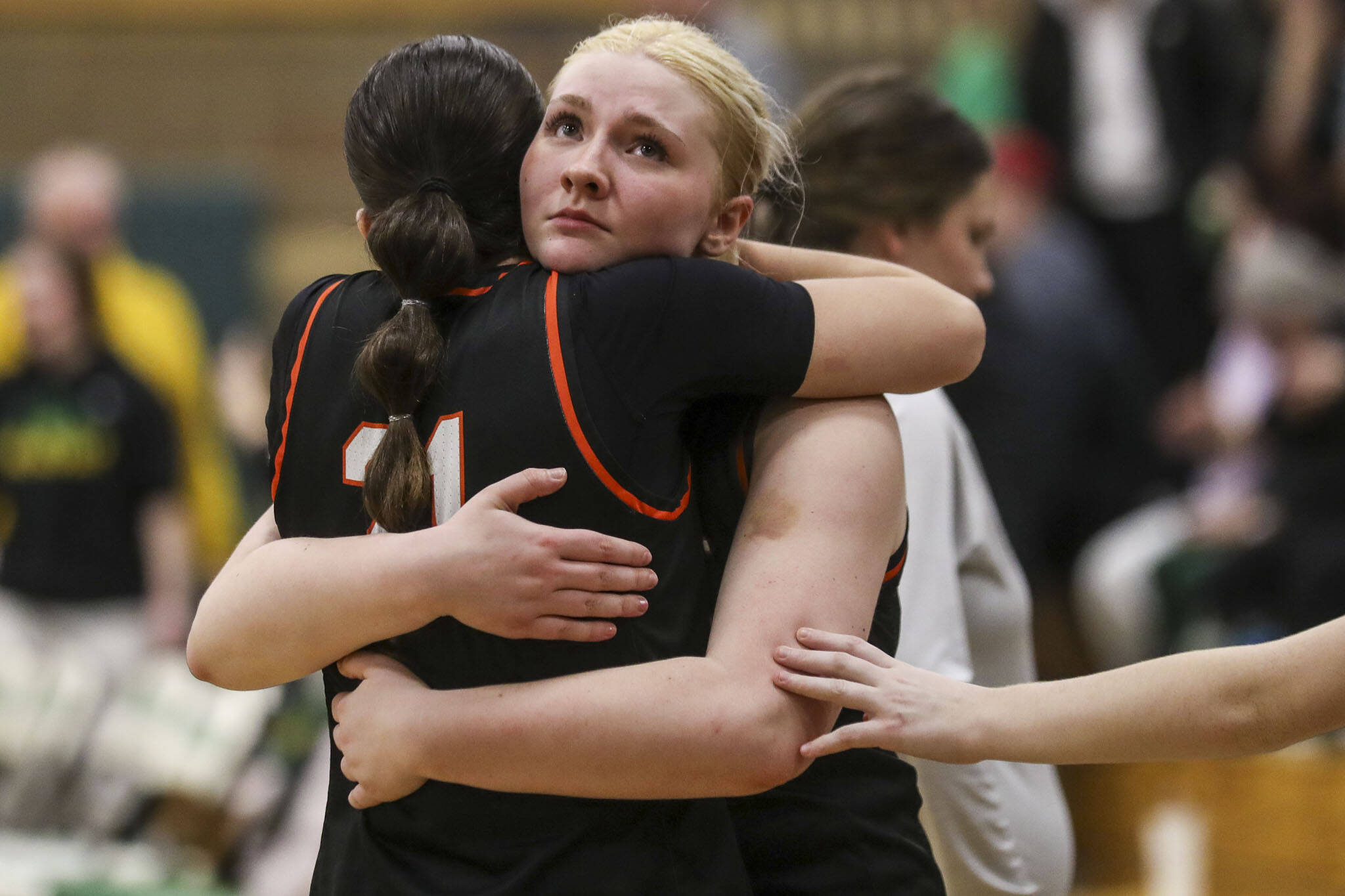 Monroe players hug after a tough loss during a 3A girls game between Monroe and Roosevelt at Roosevelt High School on Tuesday, Feb. 20, 2024, in Seattle, WA. Monroe fell, 58-37. (Annie Barker / The Herald)