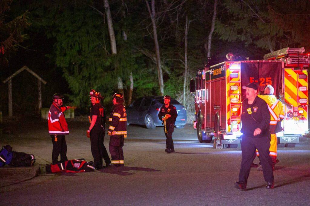 Emergency responders stage outside the Japanese Gulch 19th Street Trailhead while searching for an airplane that crashed in the area on Friday, Feb. 16, 2024, in Everett, Washington. (Ryan Berry / The Herald)

