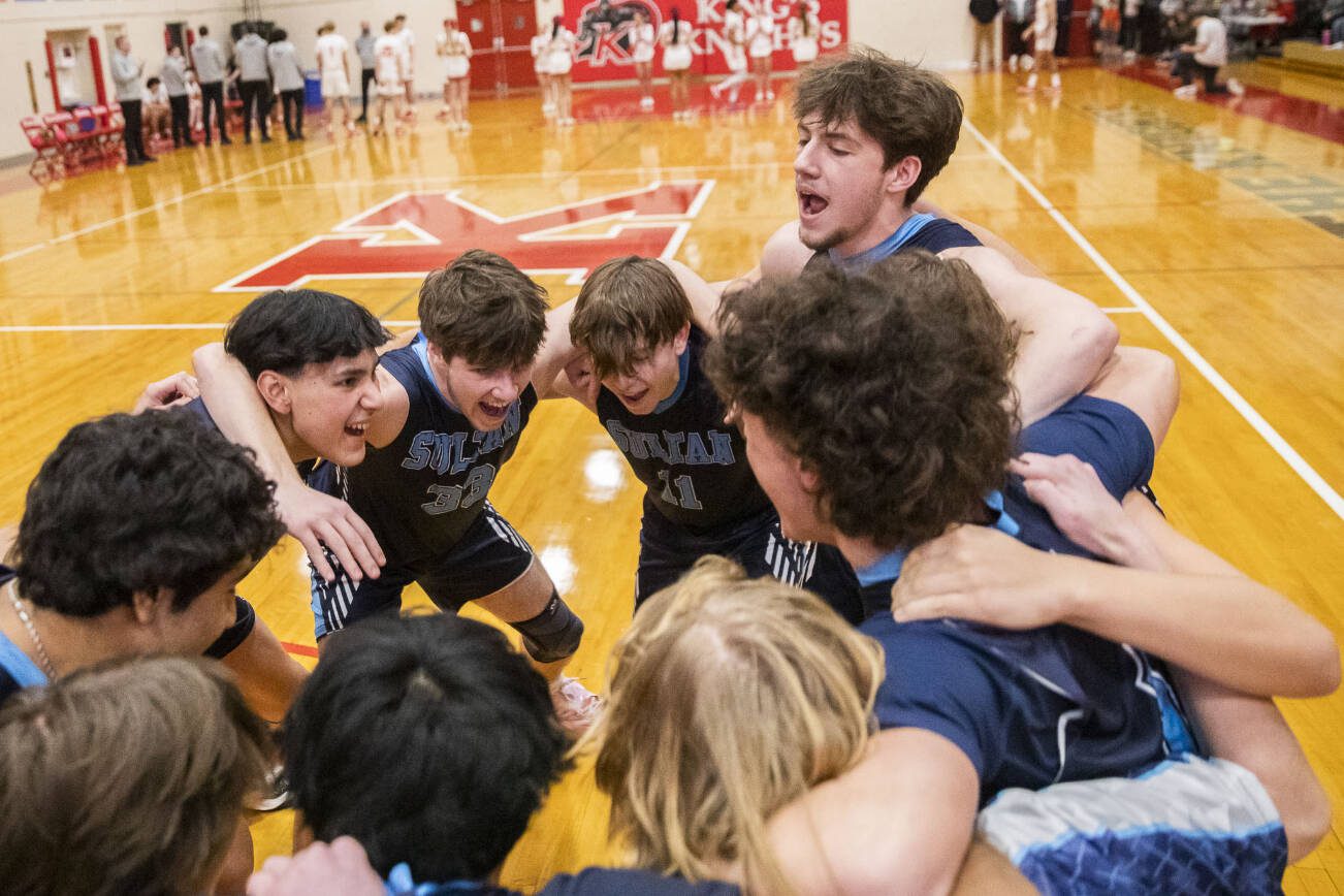 Toby Trichler, right, yells during a team cheer before the start of the game on Tuesday, Jan. 23, 2024 in Shoreline, Washington. (Olivia Vanni / The Herald)