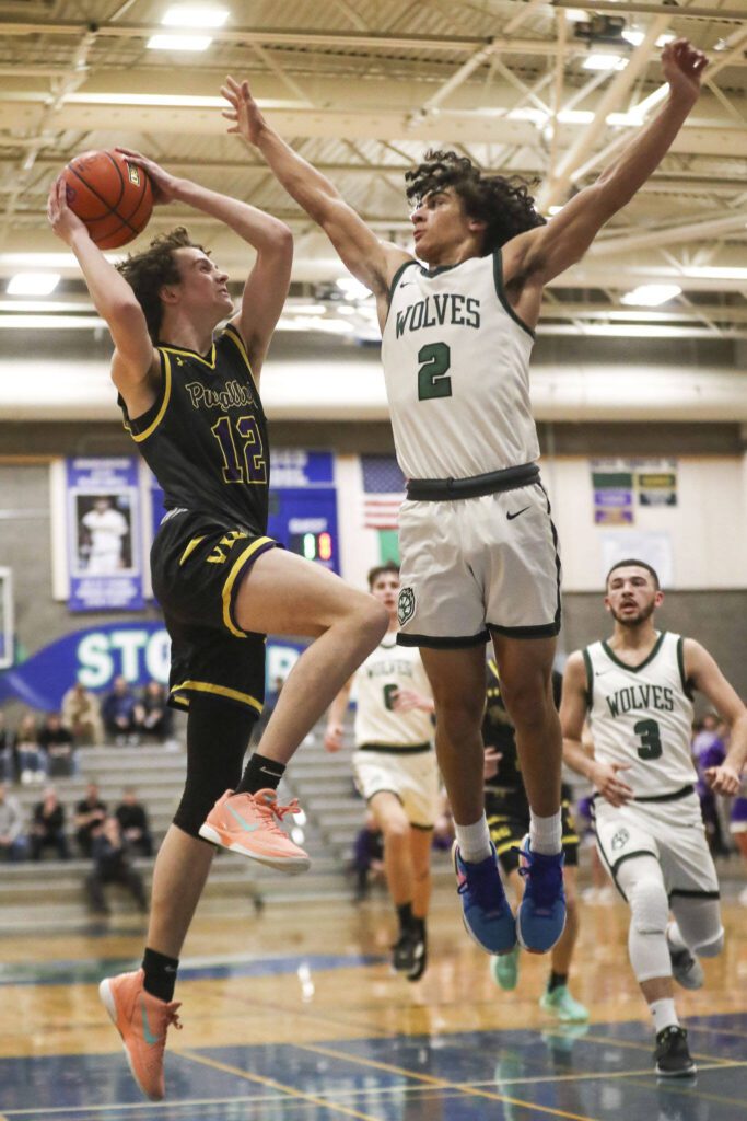Jackson’s Seamus Williams (2) contest a shot against Puyallup during a state regionals game Feb. 23 in Shoreline. (Annie Barker / The Herald)
