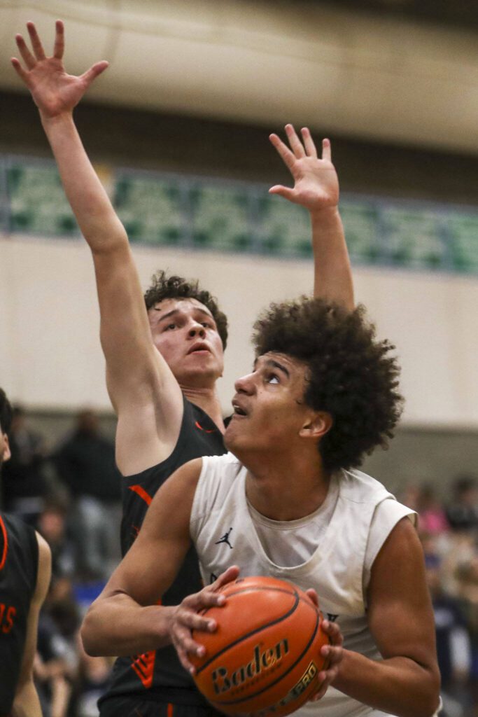 Glacier Peak’s Jayce Nelson (21) shoots the ball during a boys game between Glacier Peak and Davis at Shorewood High School on Friday, Feb. 23, 2024, in Shoreline, WA. Glacier Peak fell, 65-54.. (Annie Barker / The Herald)
