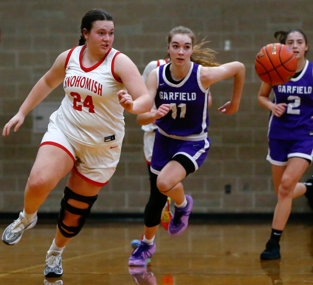 Snohomish senior Addyson Gallatin chases down a loose ball during a playoff matchup with Garfield at Arlington High School on Friday, Feb. 23, 2024, in Arlington, Washington. (Ryan Berry / The Herald)
