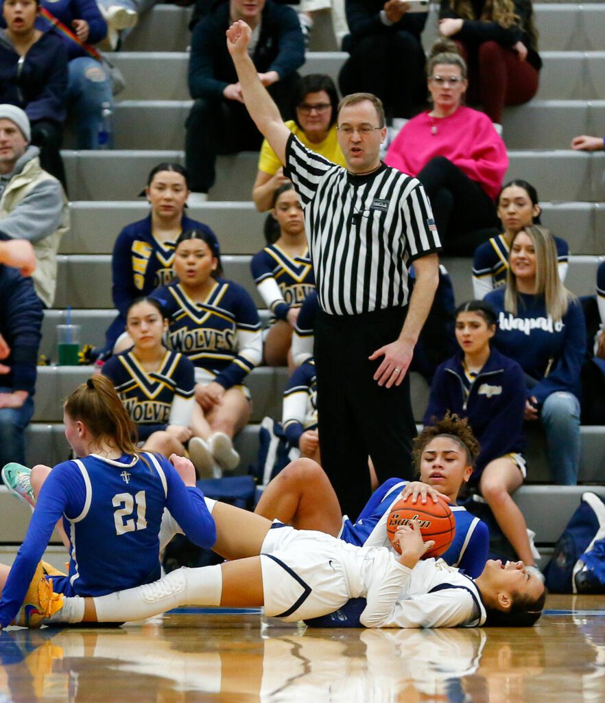 Everett senior Alana Washington winces after being fouled and sent to the floor against Seattle Prep during a playoff matchup at Shorewood High School on Saturday, Feb. 24, 2024, in Shoreline, Washington. (Ryan Berry / The Herald)
