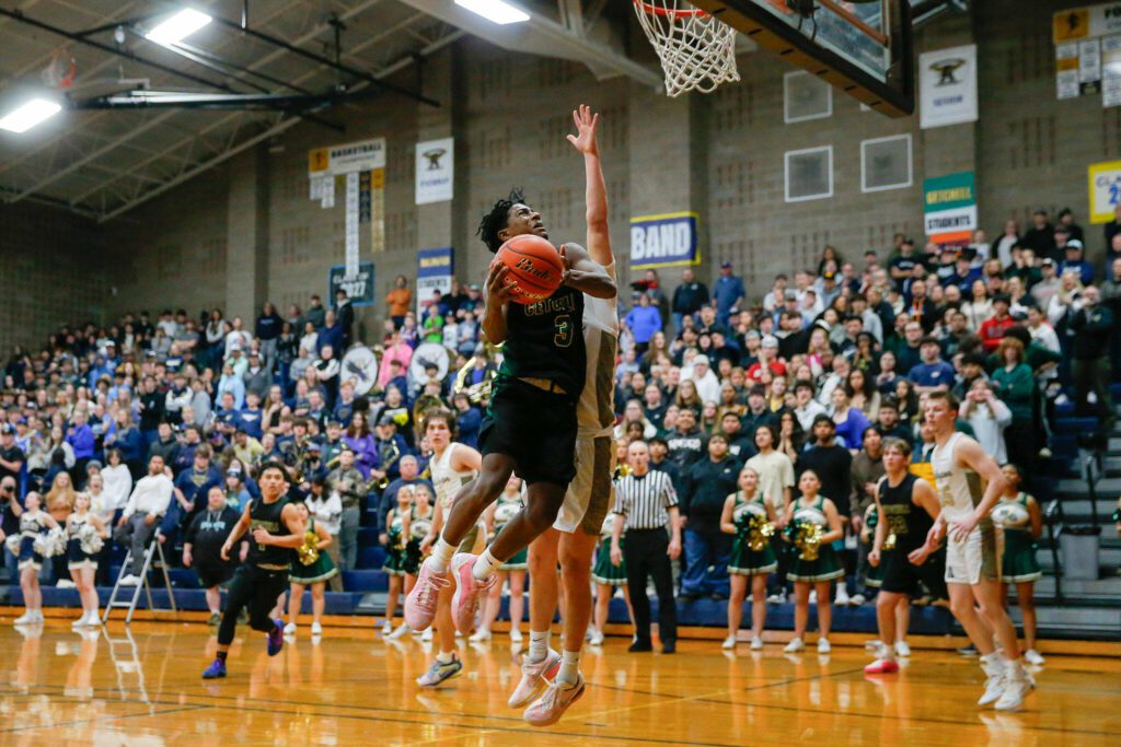 Marysville Getchell senior Shawn Etheridge goes for a layup against Arlington during a playoff matchup at Arlington High School on Saturday, Feb. 24, 2024, in Arlington, Washington. (Ryan Berry / The Herald)
