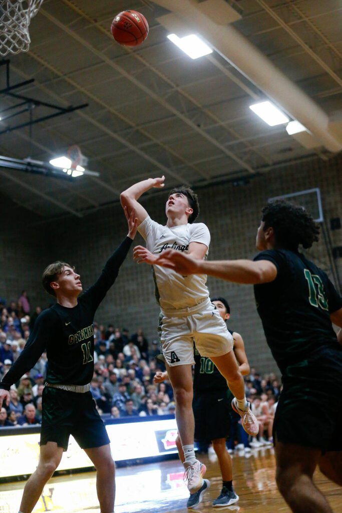 Arlington’s Jake Willis gets fouled while shooting a floater against Marysville Getchell during a playoff matchup at Arlington High School on Saturday, Feb. 24, 2024, in Arlington, Washington. (Ryan Berry / The Herald)
