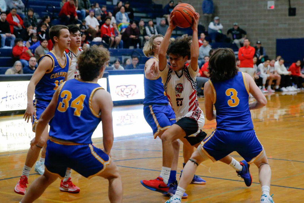 Tulalip Heritage freshman Amare’ Hatch tries to force his way to the rim against Columbia Adventist Academy during a playoff matchup at Arlington High School on Saturday, Feb. 24, 2024, in Arlington, Washington. (Ryan Berry / The Herald)
