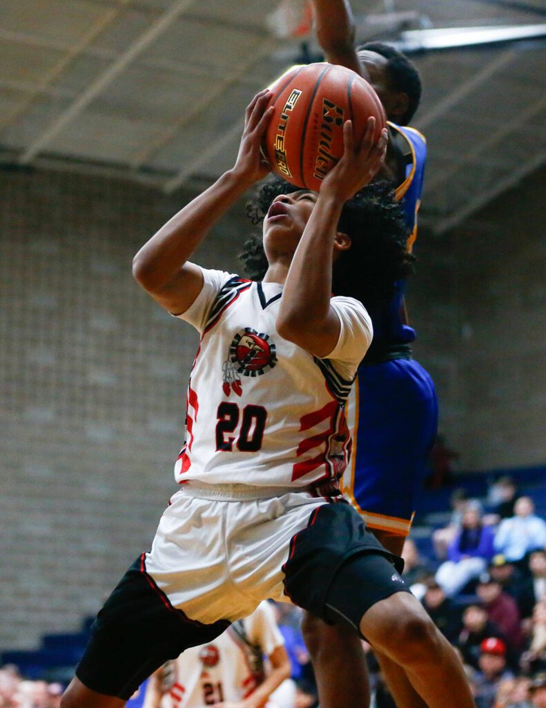 Tulalip Heritage’s Jaylan Gray gets fouled on a shot against Columbia Adventist Academy during a playoff matchup at Arlington High School on Saturday, Feb. 24, 2024, in Arlington, Washington. (Ryan Berry / The Herald)
