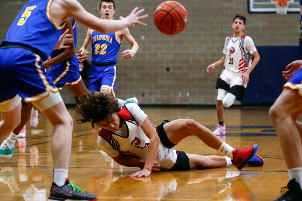 Tulalip Heritage freshman Amare’ Hatch hits the ground after getting fouled against Columbia Adventist Academy during a playoff matchup at Arlington High School on Saturday, Feb. 24, 2024, in Arlington, Washington. (Ryan Berry / The Herald)

