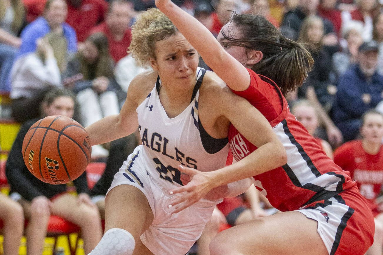 Arlington’s Samara Morrow tries to maneuver around  Snohomish’s Sienna Capelli during the 3A girls district championship game on Saturday, Feb. 17, 2024 in Marysville, Washington. (Olivia Vanni / The Herald)