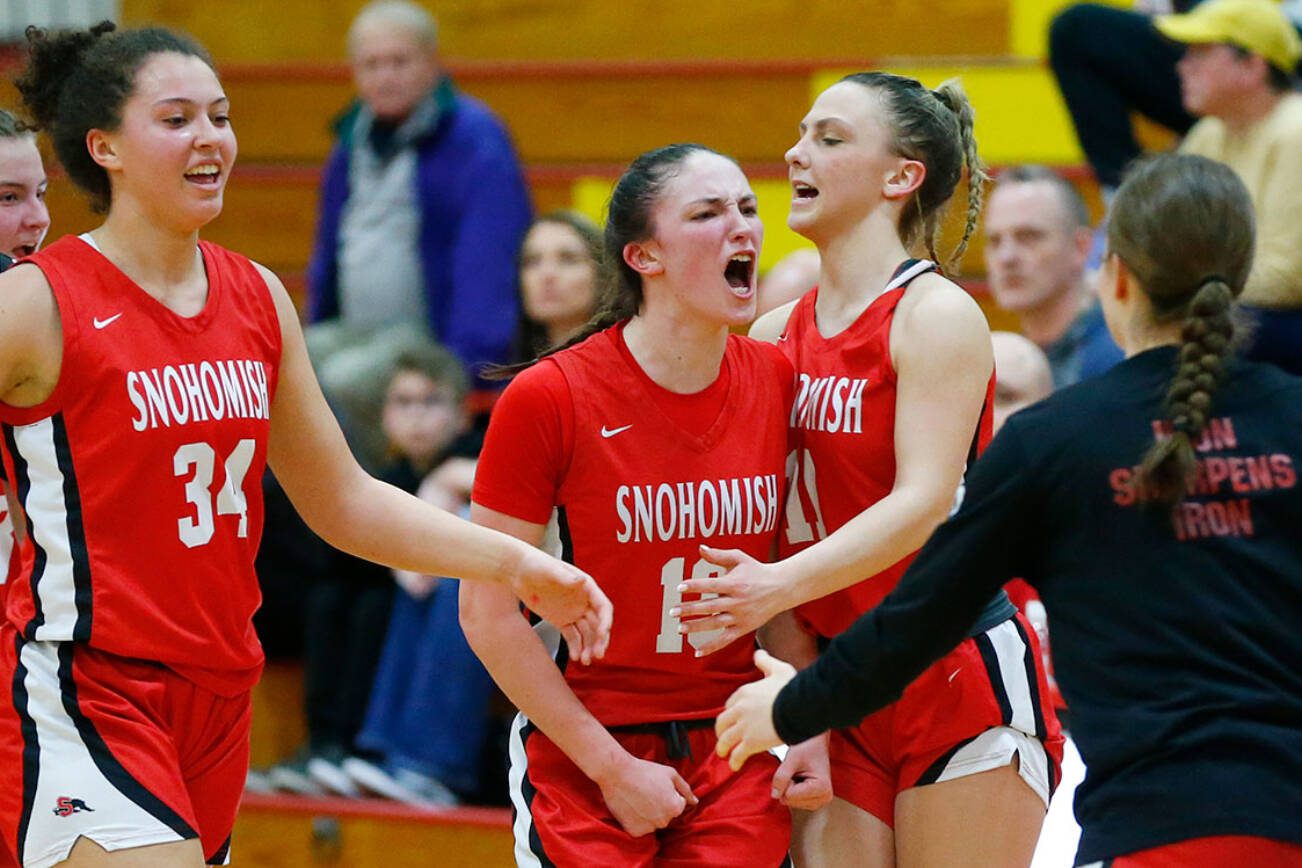 Snohomish players celebrate a strong run against Meadowdale as they head for the bench during the 3A District One Semifinals on Wednesday, Feb. 14, 2024, at Marysville Pilchuk High School in Marysville, Washington. (Ryan Berry / The Herald)
