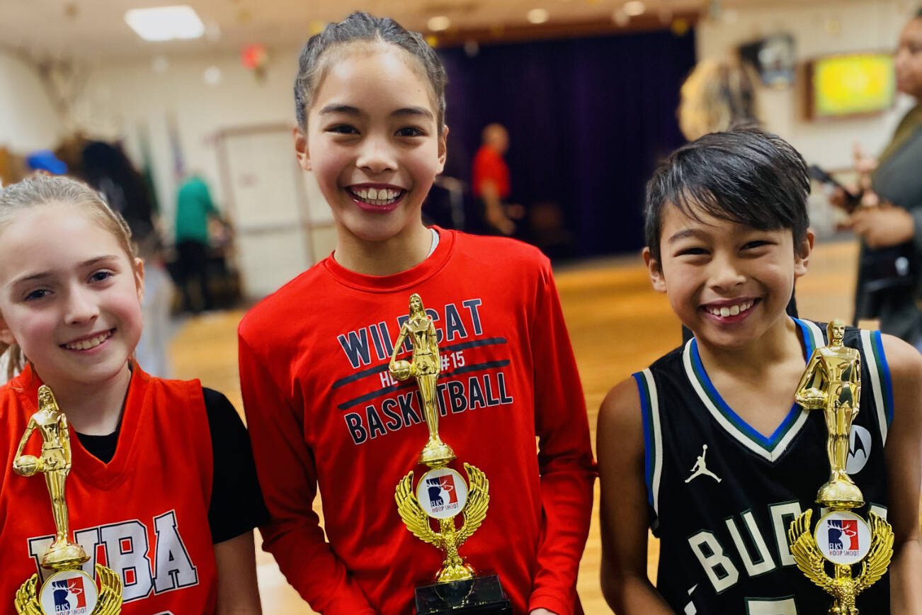(From left to right) Ellie Matisin, Helaina Soterakopoulos and Max Soterakopoulos pose with their championships trophies after winning their divisions of the Washington State Elks Association Hoop Shoot free throw competition.  (Photo courtesy of Jayne Soterakopoulos)