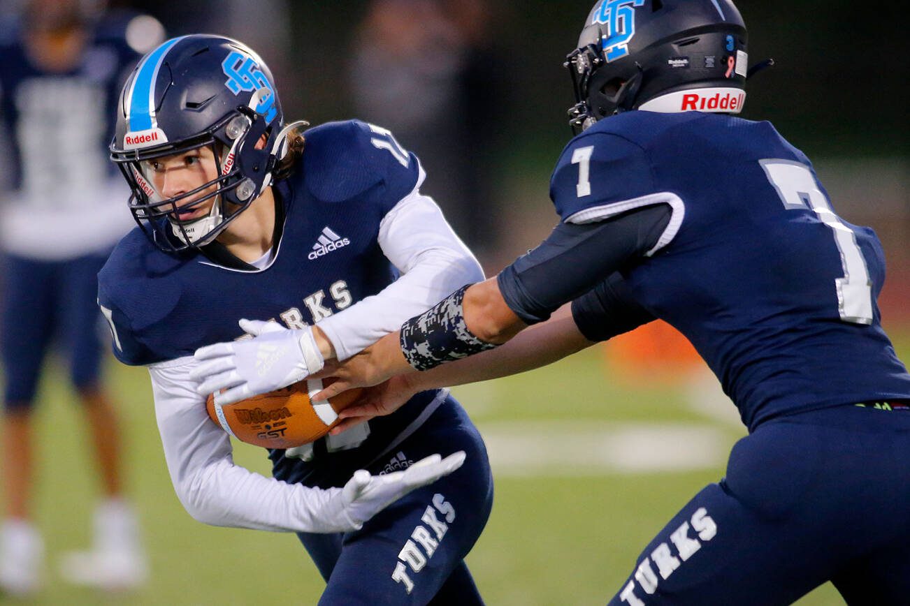 Sultan’s Derek Feltner takes a handoff from quarterback Westin Galle against Granite Falls on Friday, Sep. 30, 2022, at Sultan High School in Sultan, Washington. (Ryan Berry / The Herald)