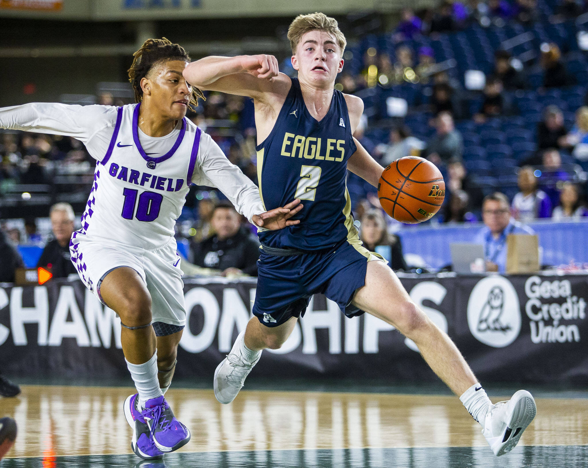 Arlington’s Leyton Martin takes the ball down the court during the 3A boys state basketball game against Garfield on Wednesday in Tacoma. (Olivia Vanni / The Herald)