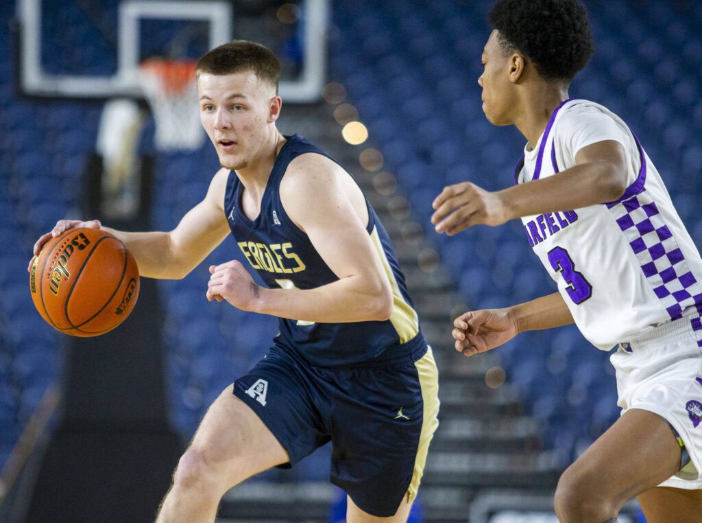 Arlington’s Jackson Trotter takes the ball down the court during the 3A boys state basketball game against Garfield on Wednesday, Feb. 28, 2024 in Tacoma, Washington. (Olivia Vanni / The Herald)
