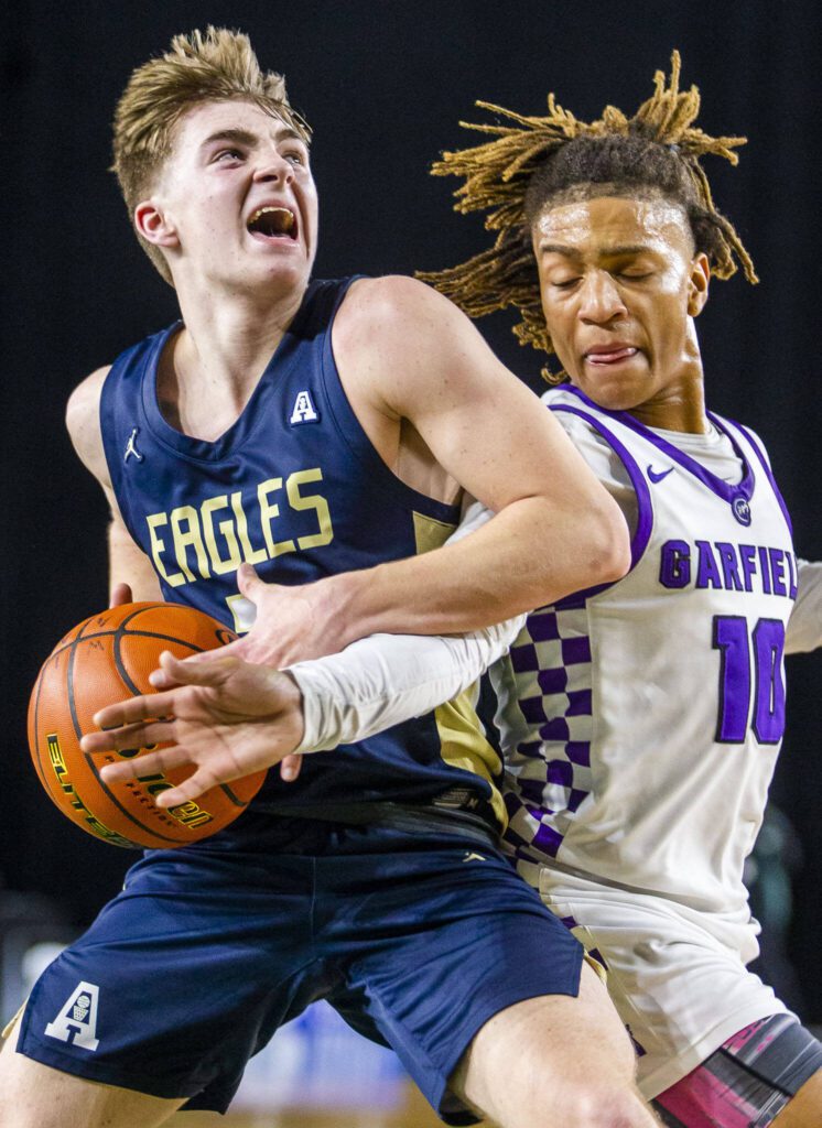 Arlington’s Leyton Martin attempts a layup while being guarded during the 3A boys state basketball game against Garfield on Wednesday, Feb. 28, 2024 in Tacoma, Washington. (Olivia Vanni / The Herald)
