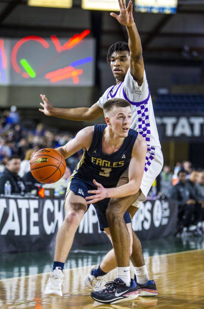 Arlington’s Jackson Trotter looks for an open teammate to pass to during the 3A boys state basketball game against Garfield on Wednesday, Feb. 28, 2024 in Tacoma, Washington. (Olivia Vanni / The Herald)
