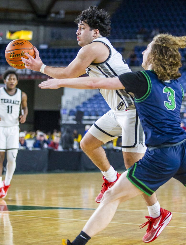 Mountlake Terrace’s Logan Tews leaps while passing the ball during the 3A boys state basketball game against Todd Beamer on Wednesday, Feb. 28, 2024 in Tacoma, Washington. (Olivia Vanni / The Herald)
