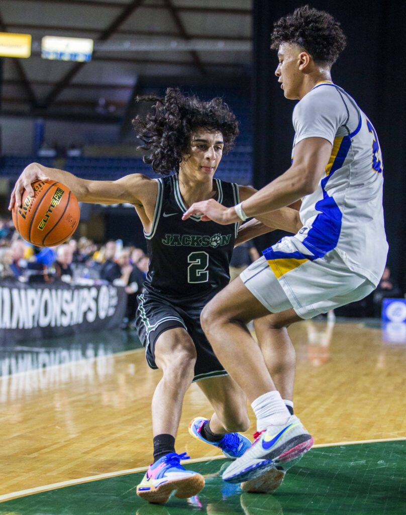 Jackson’s Seamus Williams tries to maneuver around a Tahoma player during the 4A boys state basketball game against Tahoma on Wednesday, Feb. 28, 2024 in Tacoma, Washington. (Olivia Vanni / The Herald)
