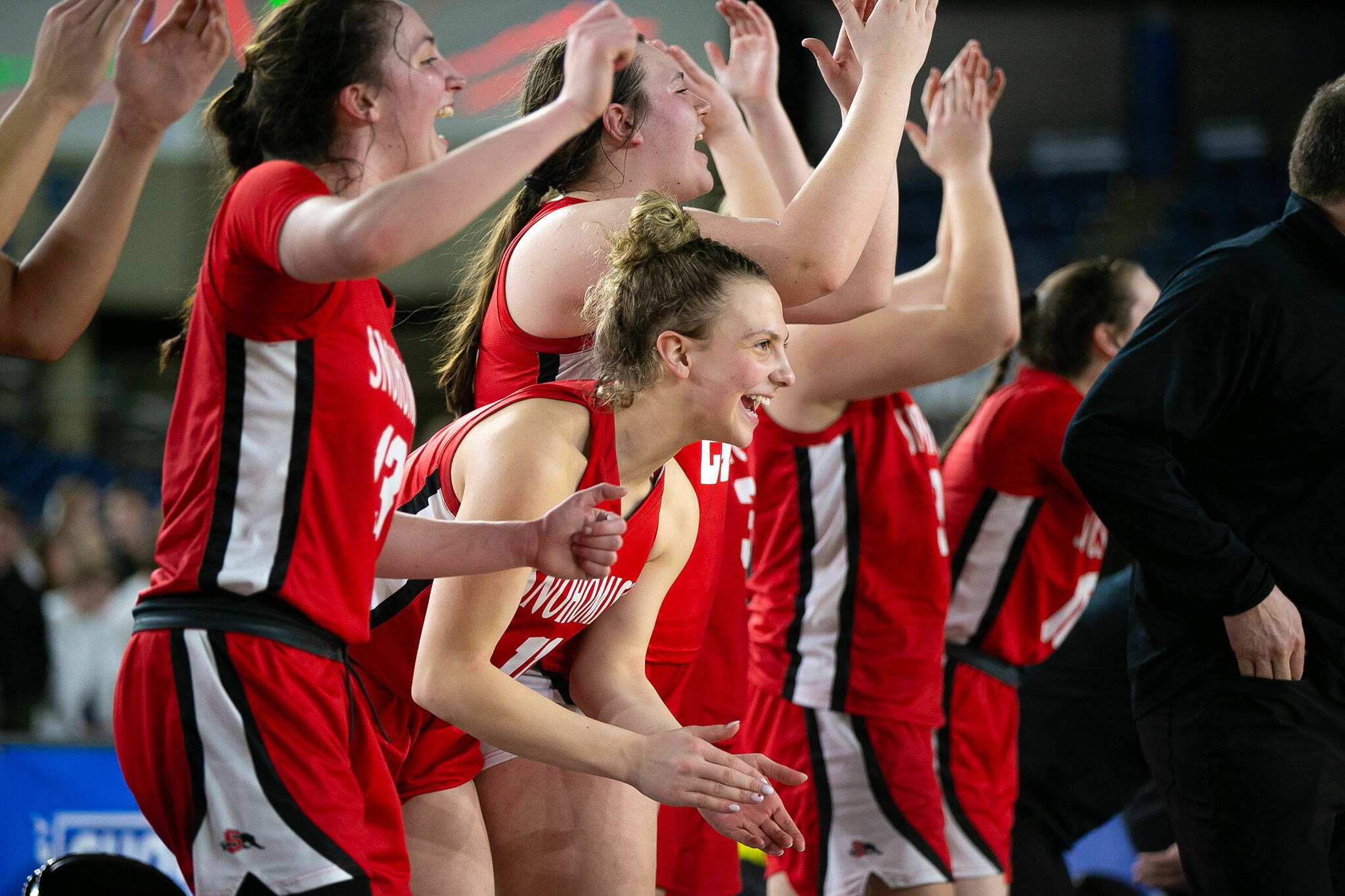 Baella Stich and the Snohomish bench celebrate their impending victory during a WIAA 3A Girls Basketball quarterfinal against Arlington on Thursday, Feb. 29, 2024, at the Tacoma Dome in Tacoma, Washington. (Ryan Berry / The Herald)