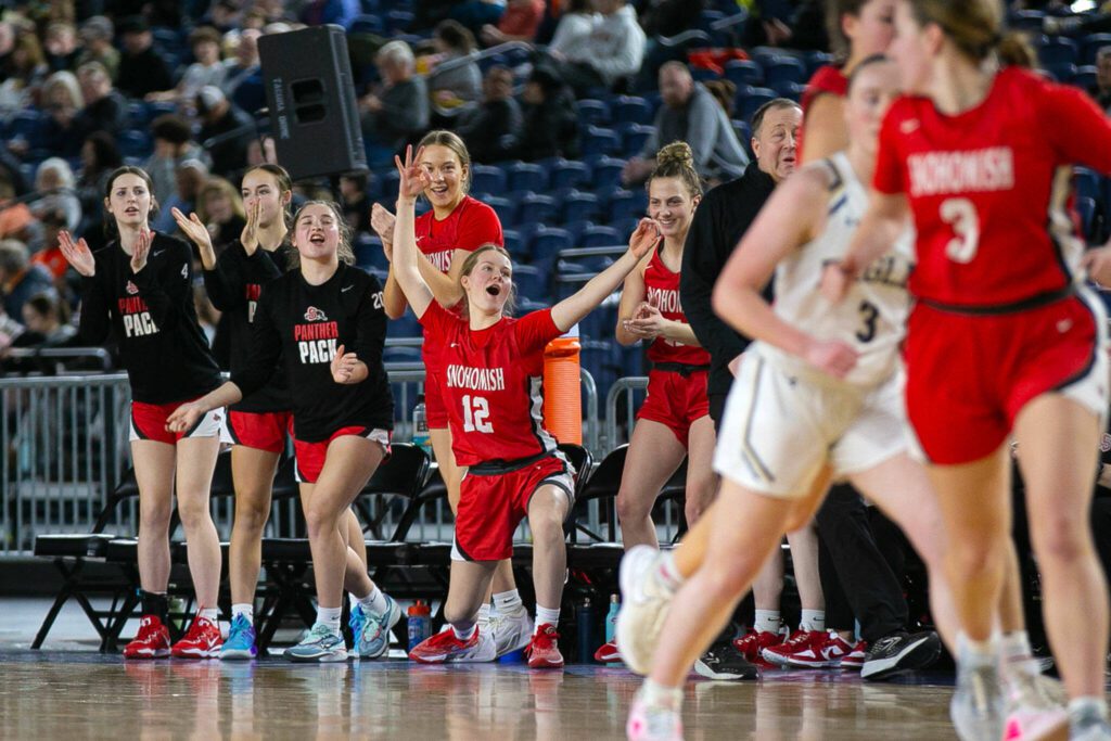 Snohomish’s bench celebrates a late three by Kendall Hammer during a WIAA 3A Girls Basketball quarterfinal against Arlington on Thursday, Feb. 29, 2024, at the Tacoma Dome in Tacoma, Washington. (Ryan Berry / The Herald)
