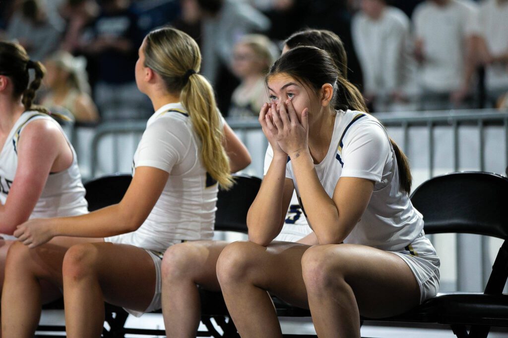 The Arlington bench loses steam as their team falls behind during a WIAA 3A Girls Basketball quarterfinal against Snohomish on Thursday, Feb. 29, 2024, at the Tacoma Dome in Tacoma, Washington. (Ryan Berry / The Herald)
