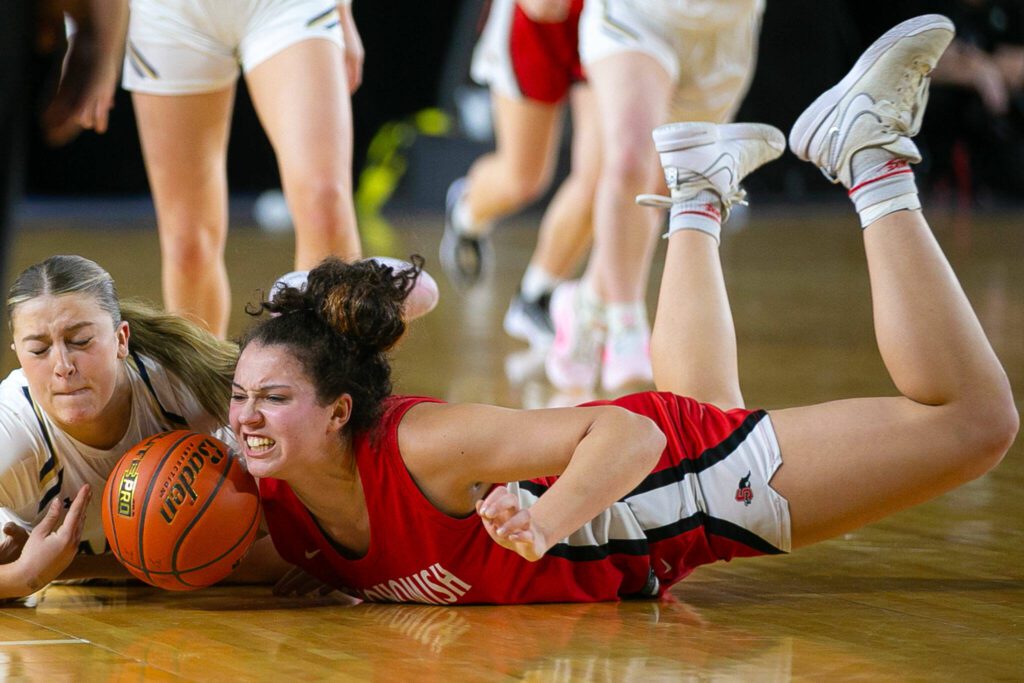 Snohomish junior Tyler Gildersleeve-Stiles hits the floor trying to get the ball during a WIAA 3A Girls Basketball quarterfinal against Arlington on Thursday, Feb. 29, 2024, at the Tacoma Dome in Tacoma, Washington. (Ryan Berry / The Herald)

