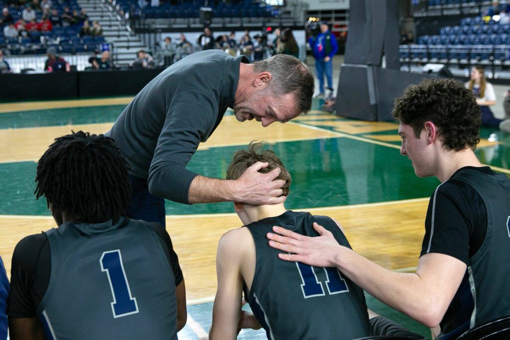Glacier Peak head coach Brian Hunter speaks positively to sophomore Reed Nagel after Nagel fouled out during a WIAA 4A Boys Basketball quarterfinal against Gonzaga Prep on Thursday, Feb. 29, 2024, at the Tacoma Dome in Tacoma, Washington. (Ryan Berry / The Herald)
