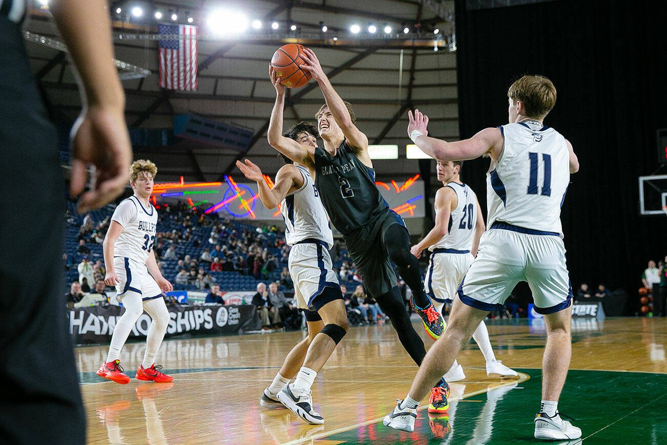 Glacier Peak junior Josiah Lee splits the defense on his way to the basket during a WIAA 4A Boys Basketball quarterfinal against Gonzaga Prep on Thursday, Feb. 29, 2024, at the Tacoma Dome in Tacoma, Washington. (Ryan Berry / The Herald)