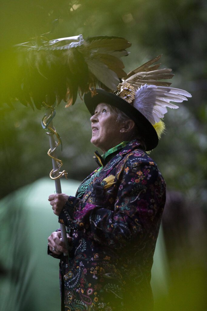 Cassandee Meter invokes the Roman god Mercury during GodCon in Index, Washington, on July 22, 2023. Invocation takes preparation: wearing the right clothes, researching the spiritual entity and making proper offerings. A host then interprets messages. From Krampus to Zeus, to depicting major arcana of the tarot, all interpretations are fair game at the Aquarian Tabernacle Church. (Annie Barker / The Herald)
