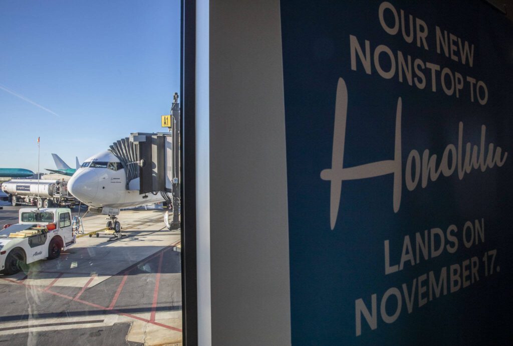 The first flight from Paine Field to Honolulu is prepared by grounds crew on Nov. 17, 2023 in Everett. (Olivia Vanni / The Herald)
