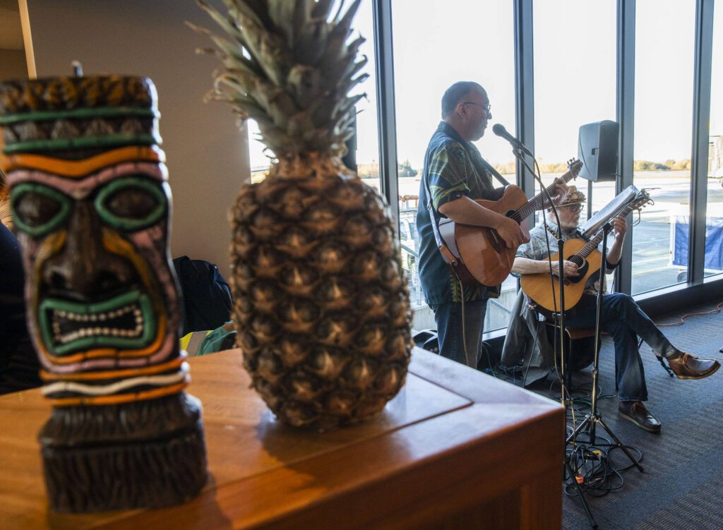 Live music is played in the terminal before the first flight from Paine Field to Honolulu on Nov. 17, 2023 in Everett. (Olivia Vanni / The Herald)
