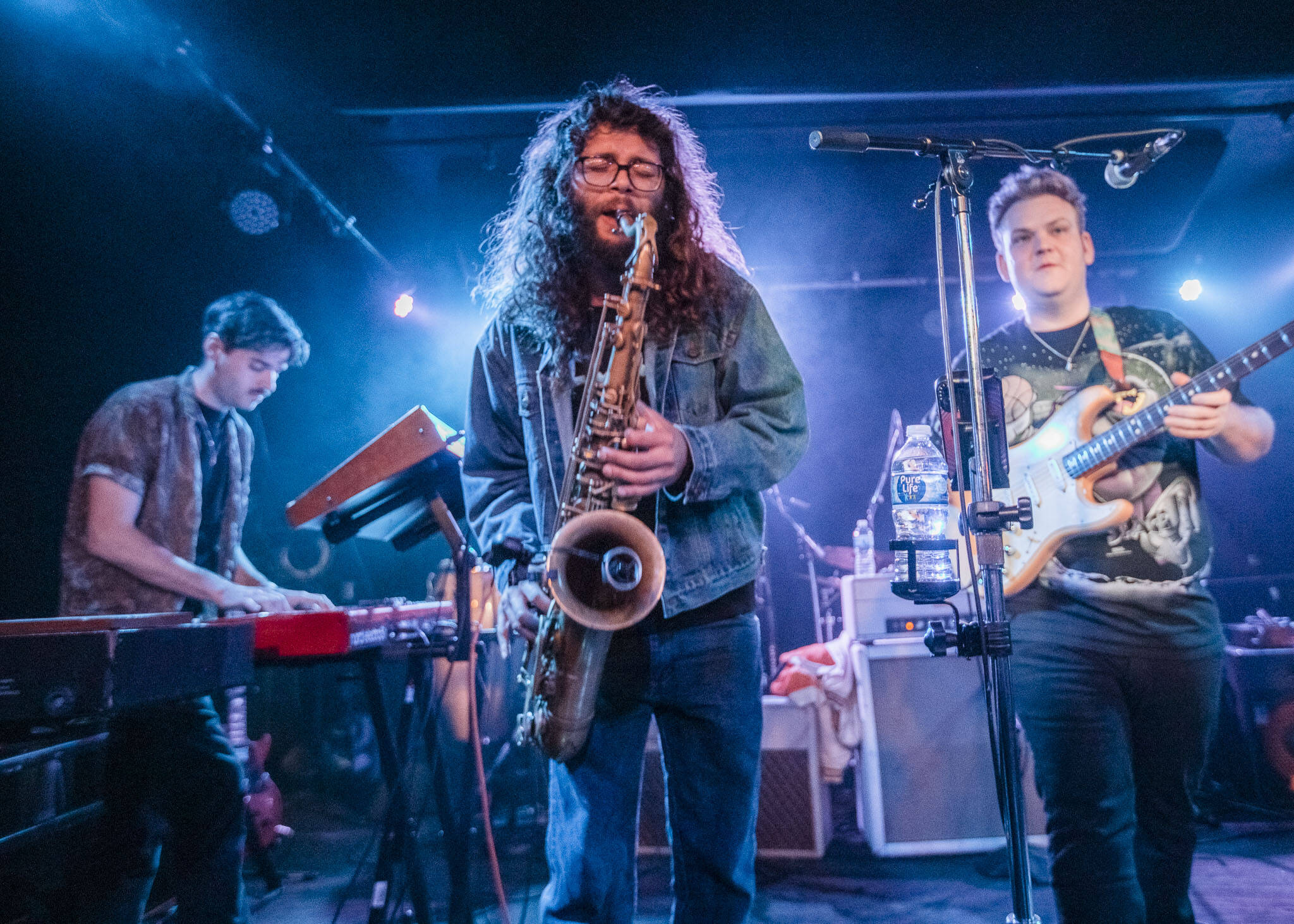 Brandon Hailey of Cytrus, center, plays the saxophone during a headlining show at Madame Lou’s on Friday, Dec. 29, 2023 in Seattle, Washington. (Olivia Vanni / The Herald)