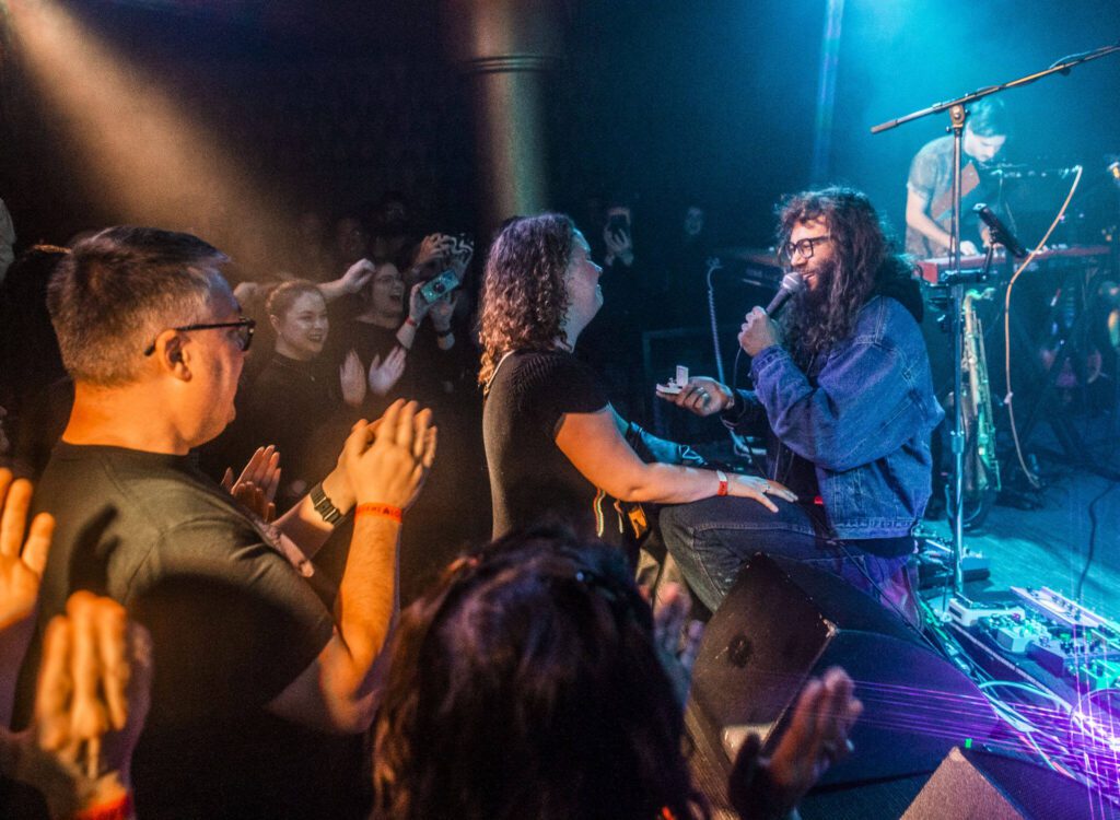 Brandon Hailey of Cytrus proposes to his girlfriend, Laila McKinley, during the bands headlining show at Madame Lou’s on Friday, Dec. 29, 2023 in Seattle, Washington. (Olivia Vanni / The Herald)
