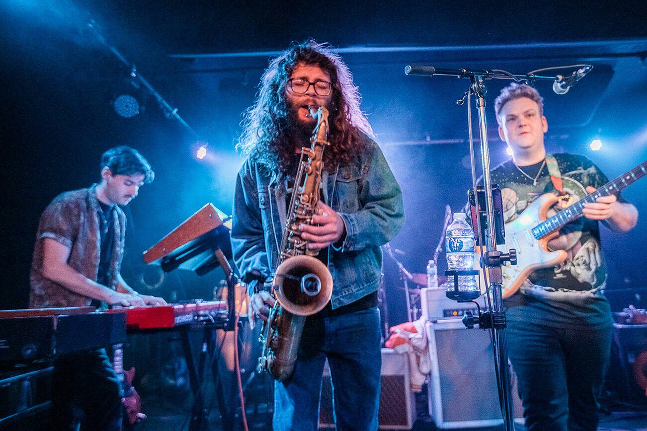Brandon Hailey of Cytrus, center, plays the saxophone during a headlining show at Madam Lou’s on Friday, Dec. 29, 2023 in Seattle, Washington. (Olivia Vanni / The Herald)