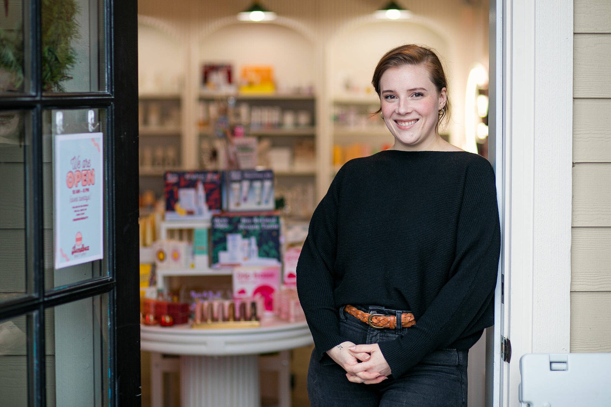 Sarah Jean Muncey-Gordon stands in the doorway of her storefront at Bandbox Beauty Supply in Langley. Bandbox focuses on stocking independent, cruelty-free, women- and minority-owned beauty brands. (Ryan Berry / The Herald)