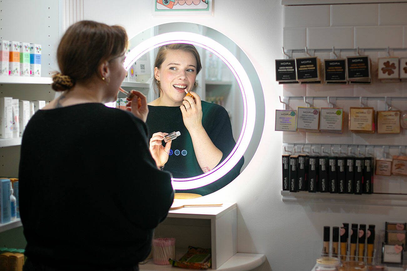 Sarah Jean Muncey-Gordon puts on some BITCHSTIX lip oil at Bandbox Beauty Supply on Tuesday, Jan. 9, 2024, in Langley, Washington. (Ryan Berry / The Herald)