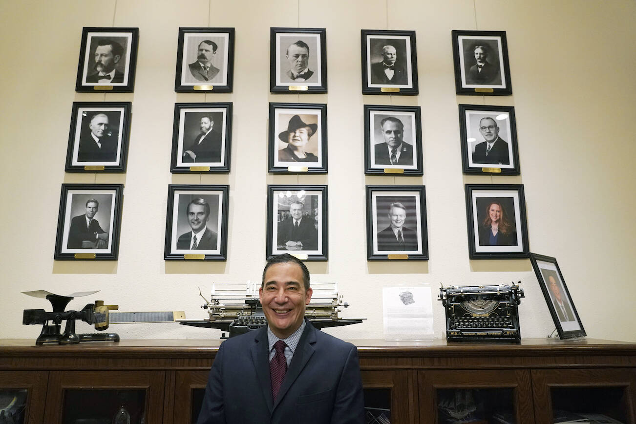 FILE - Washington Secretary of State Steve Hobbs poses in front of photos of the 15 people who previously held the office on Nov. 22, 2021, after he was sworn in at the Capitol in Olympia, Wash. Hobbs faces several challengers as he runs for election to the office he was appointed to last fall. (AP Photo/Ted S. Warren, File)