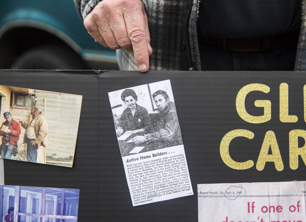 Olin points out a newspaper cutout of him as a young homebuilder on Wednesday, March 20, 2024 in Everett, Washington. (Olivia Vanni / The Herald)
