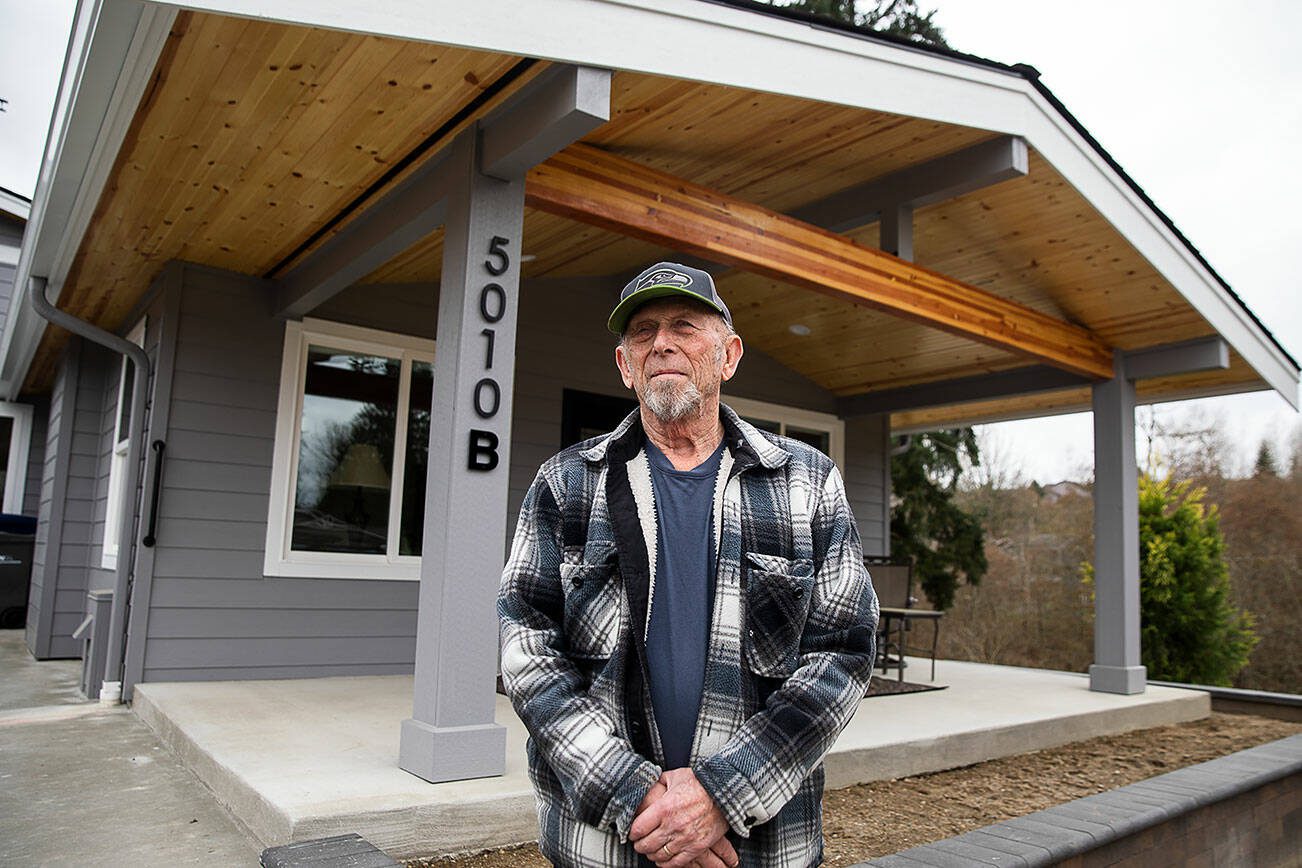 Glen Olin, 83, in front of the last home he will ever build on Wednesday, March 20, 2024 in Everett, Washington. Olin retired “sort of” after more than 60 years of building homes. (Olivia Vanni / The Herald)