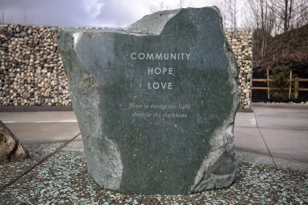 At 10:37 a.m., the exact time the slide occurred, light is supposed to hit the engraving on this boulder at the Oso Landslide Memorial. (Annie Barker / The Herald)
