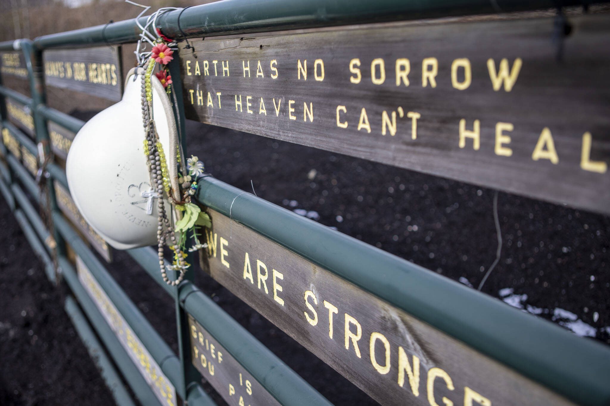Carvings with words of tribute are displayed at the Oso Landslide Memorial on Monday, Feb. 26, 2024, near Oso, Washington. (Annie Barker / The Herald)