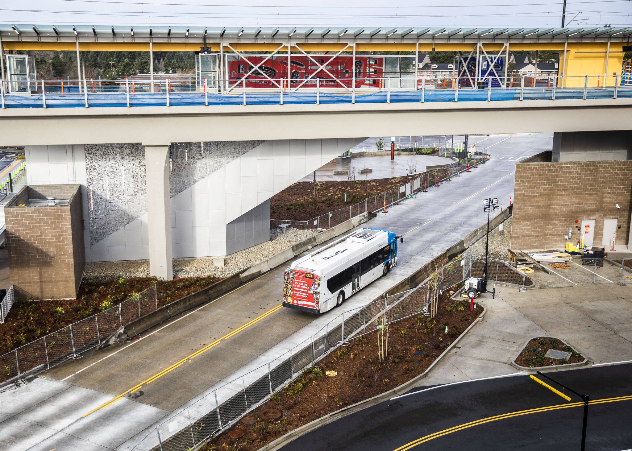 A Community Transit bus drives underneath Sound Transit’s Link Lynnwood City Center Station on Thursday, Dec. 28, 2023 in Lynnwood, Washington. (Olivia Vanni / The Herald)