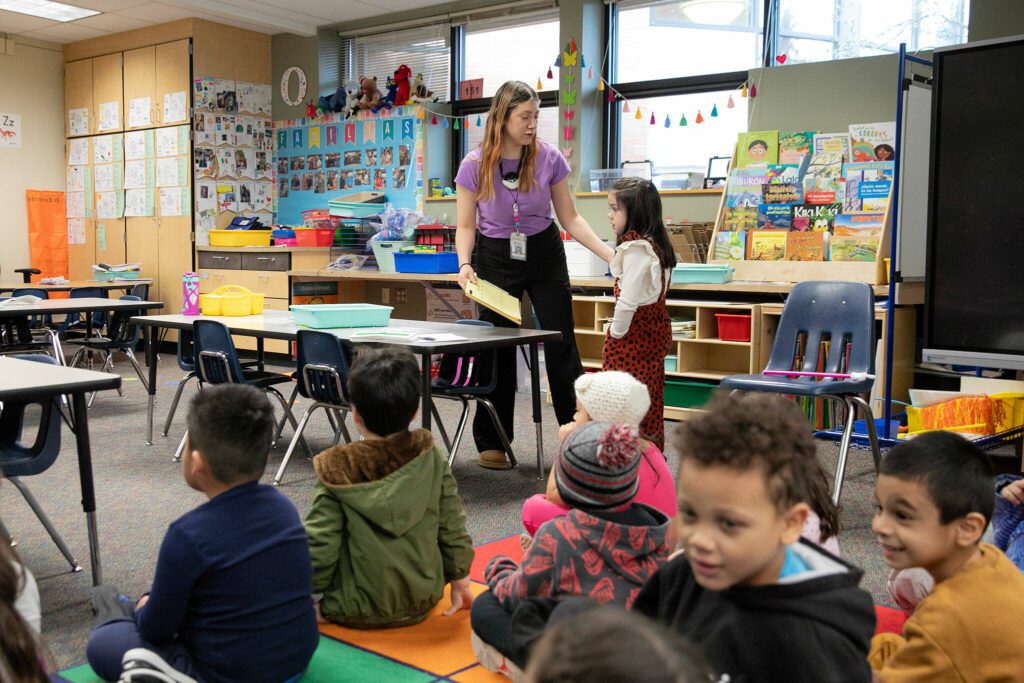 Kindergarten teacher Jasmine Ojeda-Mota divides her class into groups before going into a reading lesson at Emerson Elementary School on Wednesday, Feb. 28, 2024, in Everett, Washington. (Ryan Berry / The Herald)
