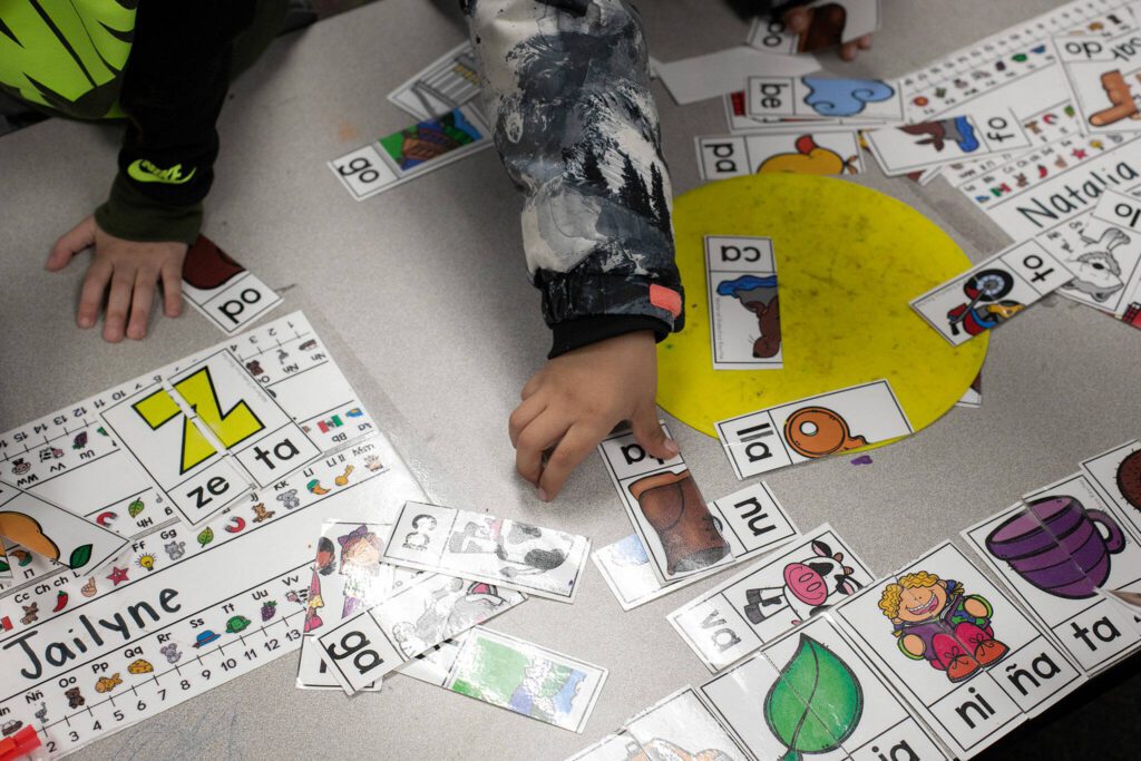 Kindergarteners work together to make two-syllable words at Emerson Elementary School on Wednesday, Feb. 28, 2024, in Everett, Washington. (Ryan Berry / The Herald)
