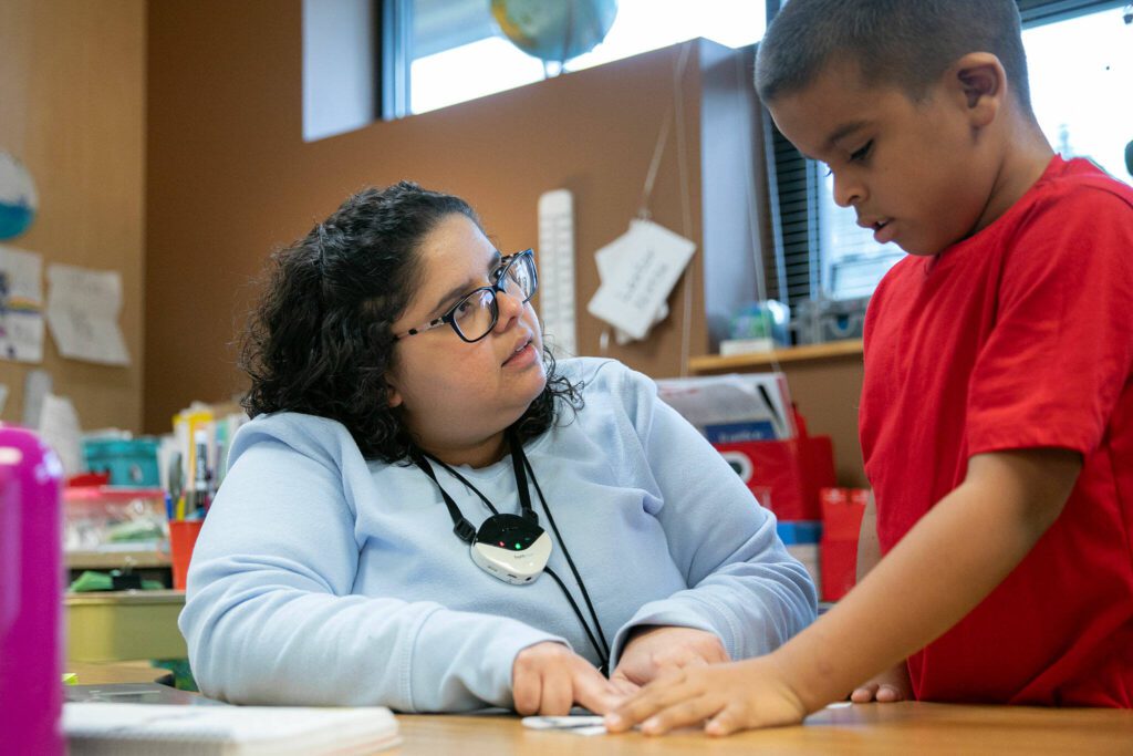 Second grade teacher Paola Martinez works on pronunciations with a student during class at Emerson Elementary School on Wednesday, Feb. 28, 2024, in Everett, Washington. (Ryan Berry / The Herald)
