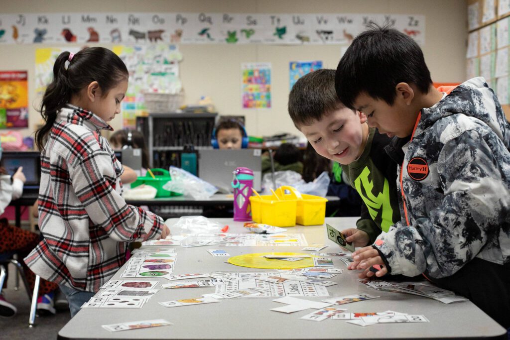 Students work together to create words with flashcards at Emerson Elementary School on Wednesday, Feb. 28, 2024, in Everett, Washington. (Ryan Berry / The Herald)
