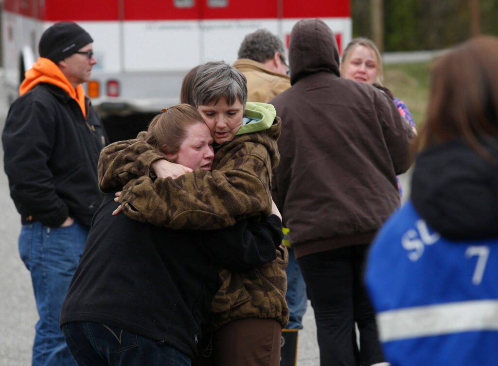 Neighbors gather at the Oso Fire Department to look for updates about the fatal mudslide that washed over homes and over Highway 530 east of Oso, Wash., Saturday morning, March 22, 2014. Highway 530 was closed in both directions, and authorities confirmed at least 2 fatalities by Saturday afternoon. (Annie Mulligan / For The Herald)
