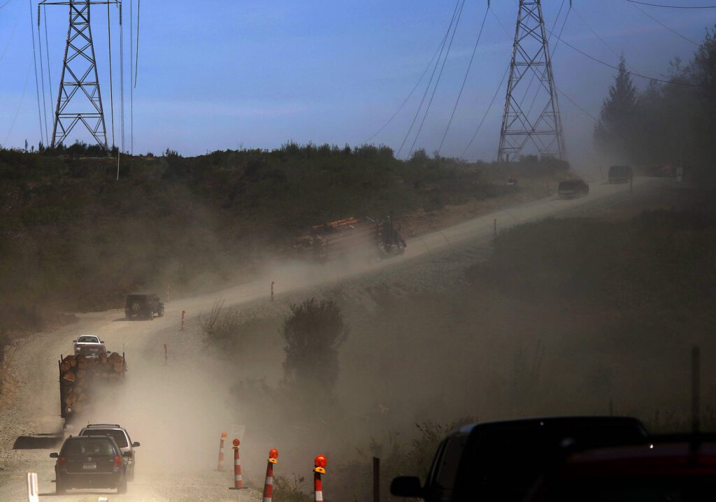 Vehicles kick up dust as they travel eastbound on the service road bypass of Highway 530 toward Darrington April 29, 2014. (Mark Mulligan / The Herald)
