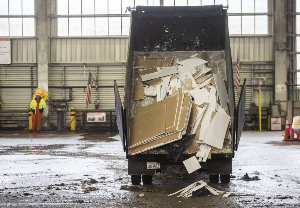 A truck dumps sheet rock onto the floor at Airport Road Recycling and Transfer Station on Thursday, Nov. 30, 2023 in Everett, Washington. (Olivia Vanni / The Herald)
